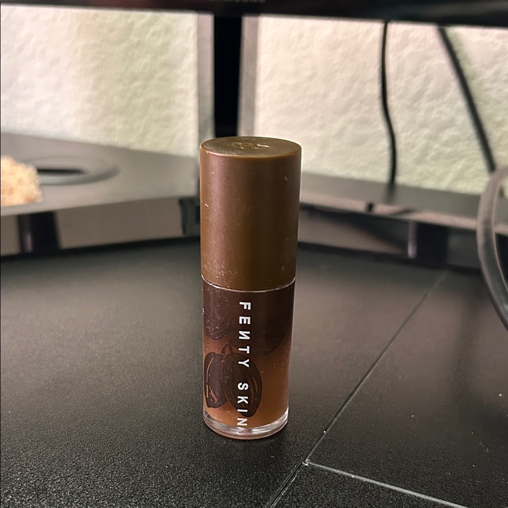 Fenty Beauty by Rihanna 
Fenty Treatz Hydrating + Strengthening Lip Oil